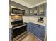 Well-lit kitchen features gray cabinets, stainless steel appliances, and white countertops at 11216 Carmel Chace Dr, Charlotte, NC 28226