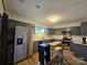 Updated kitchen with gray cabinets, stainless steel appliances, and breakfast bar at 11216 Carmel Chace Dr, Charlotte, NC 28226