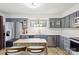 Modern kitchen featuring stainless steel appliances, gray cabinetry, and quartz countertops at 11216 Carmel Chace Dr, Charlotte, NC 28226