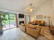 Bright living room with modern furniture, fireplace, and sliding glass doors to the backyard at 11216 Carmel Chace Dr, Charlotte, NC 28226