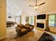 Bright living room with a fireplace, vaulted ceiling, and dining area nearby at 11216 Carmel Chace Dr, Charlotte, NC 28226