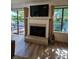 Cozy living room with fireplace, large windows, and access to the backyard at 11216 Carmel Chace Dr, Charlotte, NC 28226