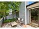 Outdoor patio area featuring a bench, small table, and sliding glass doors for easy access at 11216 Carmel Chace Dr, Charlotte, NC 28226