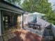 Charming patio with outdoor dining set, umbrella, and access to indoor living space at 11216 Carmel Chace Dr, Charlotte, NC 28226