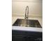 Close-up of a stainless steel kitchen sink with a modern faucet and white countertops at 11216 Carmel Chace Dr, Charlotte, NC 28226