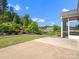 Well-maintained backyard featuring a patio, lush landscaping, mature trees, and a screened-in porch at 11931 The Ramble Dr, Huntersville, NC 28078