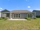 Well-manicured backyard with a covered porch, and beautiful landscaping at 11931 The Ramble Dr, Huntersville, NC 28078