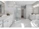 Bright, spacious bathroom features double vanities, a glass shower, and soaking tub at 11931 The Ramble Dr, Huntersville, NC 28078