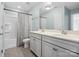 Well-lit bathroom with double vanity, tiled floors, and tub/shower combo at 11931 The Ramble Dr, Huntersville, NC 28078