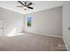 Neutral bedroom with carpet, window for natural light, and ceiling fan at 11931 The Ramble Dr, Huntersville, NC 28078