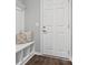 Cozy entryway featuring bench with storage, decorative pillows, coat hooks and hardwood flooring at 11931 The Ramble Dr, Huntersville, NC 28078