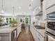 Modern kitchen featuring a large island, stainless steel appliances, and a view of the living area at 11931 The Ramble Dr, Huntersville, NC 28078
