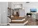Stairway landing area with a built-in desk, and open view to living space with tv at 11931 The Ramble Dr, Huntersville, NC 28078