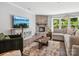 Inviting living room boasts a stone fireplace, plush seating, and a view of the outdoors at 11931 The Ramble Dr, Huntersville, NC 28078