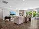 Bright living room with stone fireplace, hardwood floors, and large windows offering natural light at 11931 The Ramble Dr, Huntersville, NC 28078