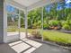 Cozy screened-in porch with serene views of the lush, landscaped backyard and mature trees at 11931 The Ramble Dr, Huntersville, NC 28078