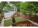 View of the backyard featuring a tiered deck, fenced yard, and mature trees offering shade at 12224 Huntersville Concord Rd, Huntersville, NC 28078