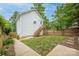A cozy backyard features a white house, wooden stairs, and a well-maintained lawn with a wooden fence at 12224 Huntersville Concord Rd, Huntersville, NC 28078