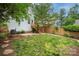A backyard with lush green lawn, wooden stairs, an AC unit, and a wooden fence at 12224 Huntersville Concord Rd, Huntersville, NC 28078