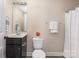 Functional bathroom featuring a sink, modern vanity, and toilet with stylish and easy access shower curtain at 12224 Huntersville Concord Rd, Huntersville, NC 28078