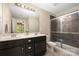 Well-lit bathroom featuring a double sink vanity with a tiled shower and glass door at 12224 Huntersville Concord Rd, Huntersville, NC 28078