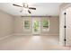 Spacious bedroom with a ceiling fan, plenty of natural light and access to a private balcony at 12224 Huntersville Concord Rd, Huntersville, NC 28078