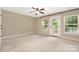 Bright and airy bedroom features a ceiling fan, and access to a private balcony at 12224 Huntersville Concord Rd, Huntersville, NC 28078