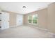 Comfortable bedroom with neutral walls, carpeted flooring and ample natural light from windows at 12224 Huntersville Concord Rd, Huntersville, NC 28078