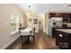Sunlit dining room features hardwood floors and a view of the front yard through large windows at 12224 Huntersville Concord Rd, Huntersville, NC 28078