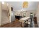 Open dining room boasts hardwood floors, stylish lighting, and seamless transition to the kitchen at 12224 Huntersville Concord Rd, Huntersville, NC 28078