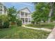 Charming two-story home boasts a double porch, well-manicured lawn, and lush greenery at 12224 Huntersville Concord Rd, Huntersville, NC 28078