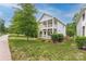 Two-story home with white siding, double porches, and a well-manicured lawn at 12224 Huntersville Concord Rd, Huntersville, NC 28078