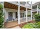 Inviting front porch with decorative door, flower pots, and a cozy seating area at 12224 Huntersville Concord Rd, Huntersville, NC 28078