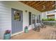 Inviting front porch with rocking chairs, plants and decorative wreath on the front door at 12224 Huntersville Concord Rd, Huntersville, NC 28078