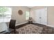 Bright home office features hardwood floors, natural light, and closet for additional storage at 12224 Huntersville Concord Rd, Huntersville, NC 28078