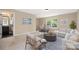 A well-lit living room featuring stylish furniture, neutral color palette, and an adjacent bathroom at 12224 Huntersville Concord Rd, Huntersville, NC 28078