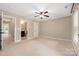 Large primary bedroom with en-suite bath, ceiling fan, and plenty of closet space at 12224 Huntersville Concord Rd, Huntersville, NC 28078