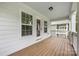 Charming outdoor porch featuring white siding and classic wood flooring with natural light at 12224 Huntersville Concord Rd, Huntersville, NC 28078
