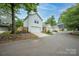 Street view featuring detached garages and well-maintained landscaping in a residential neighborhood at 12224 Huntersville Concord Rd, Huntersville, NC 28078