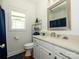 Bathroom featuring a white vanity, framed mirror, and blue accents at 125 Mariner Pointe Ln, Mooresville, NC 28117
