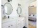 Well-lit bathroom featuring dual sinks, modern fixtures, and an adjoining bedroom at 125 Mariner Pointe Ln, Mooresville, NC 28117