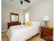 Bright bedroom with neutral walls, dark wood furnishings, and tile floor at 125 Mariner Pointe Ln, Mooresville, NC 28117