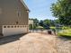 Spacious driveway leads to an attached garage with lake views at 125 Mariner Pointe Ln, Mooresville, NC 28117