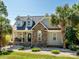Charming home featuring a stone facade, dormer windows, and a landscaped front yard at 125 Mariner Pointe Ln, Mooresville, NC 28117