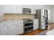 Updated kitchen with stainless steel appliances, white cabinetry, and modern countertops at 125 Mariner Pointe Ln, Mooresville, NC 28117