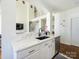 Modern kitchen features stainless steel appliances, white cabinets, stone countertops, and a breakfast bar at 125 Mariner Pointe Ln, Mooresville, NC 28117