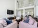 Well-lit living room with hardwood floors, a large television, and an open layout, perfect for gathering at 125 Mariner Pointe Ln, Mooresville, NC 28117