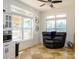 Bright sitting room with large windows, tile floors, and a comfortable reclining love seat at 125 Mariner Pointe Ln, Mooresville, NC 28117