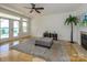 Spacious living room with fireplace, gray ottoman and beautiful lake view access at 125 Mariner Pointe Ln, Mooresville, NC 28117