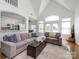 Open-concept living room with hardwood floors, high ceilings, and access to outdoor views, creating a bright space at 125 Mariner Pointe Ln, Mooresville, NC 28117